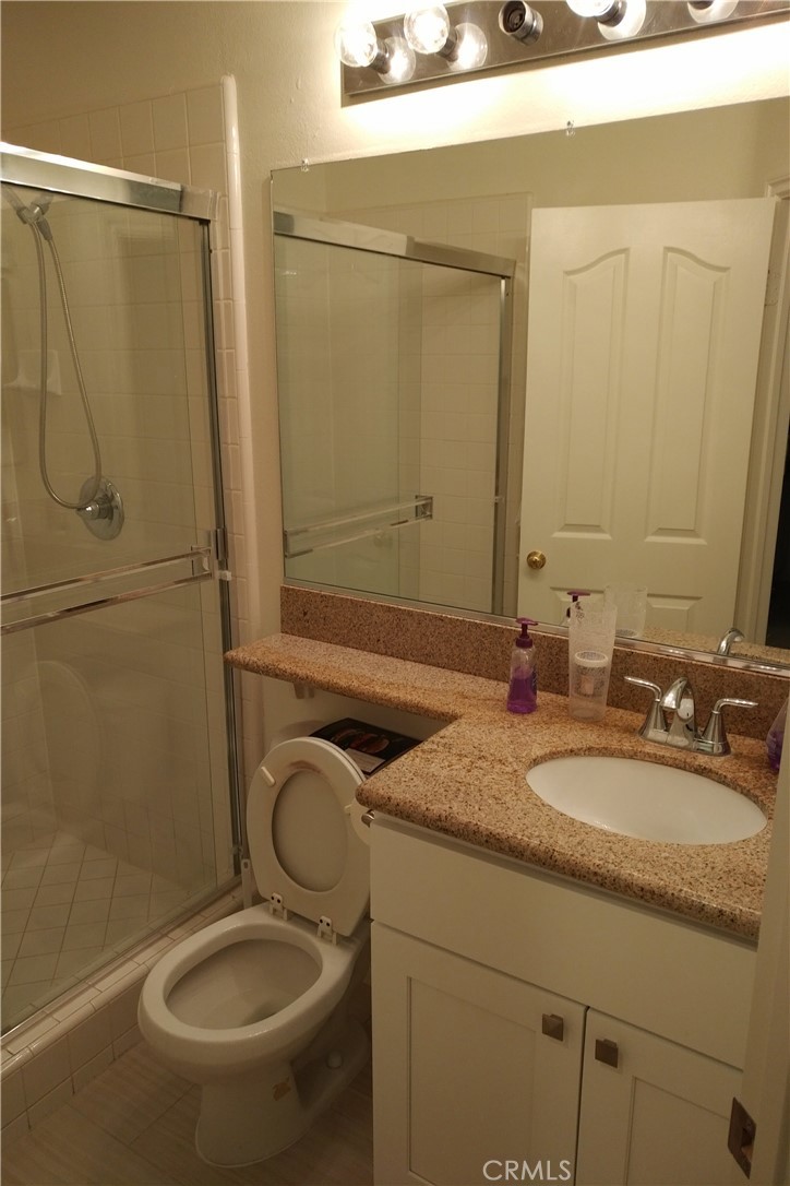 18536 Vantage Pointe Drive Rowland Heights, CA 91748 - Photo 17 of 34 a bathroom with a granite countertop toilet sink and mirror