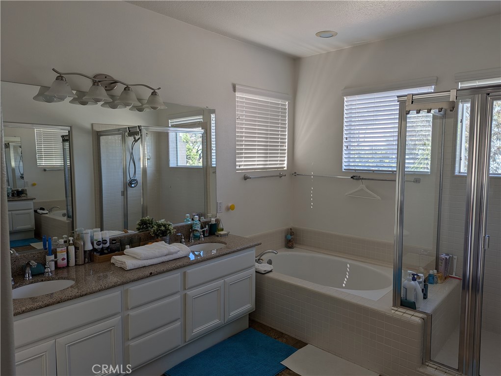 18536 Vantage Pointe Drive Rowland Heights, CA 91748 - Photo 28 of 34 a bathroom with a tub sink and mirror