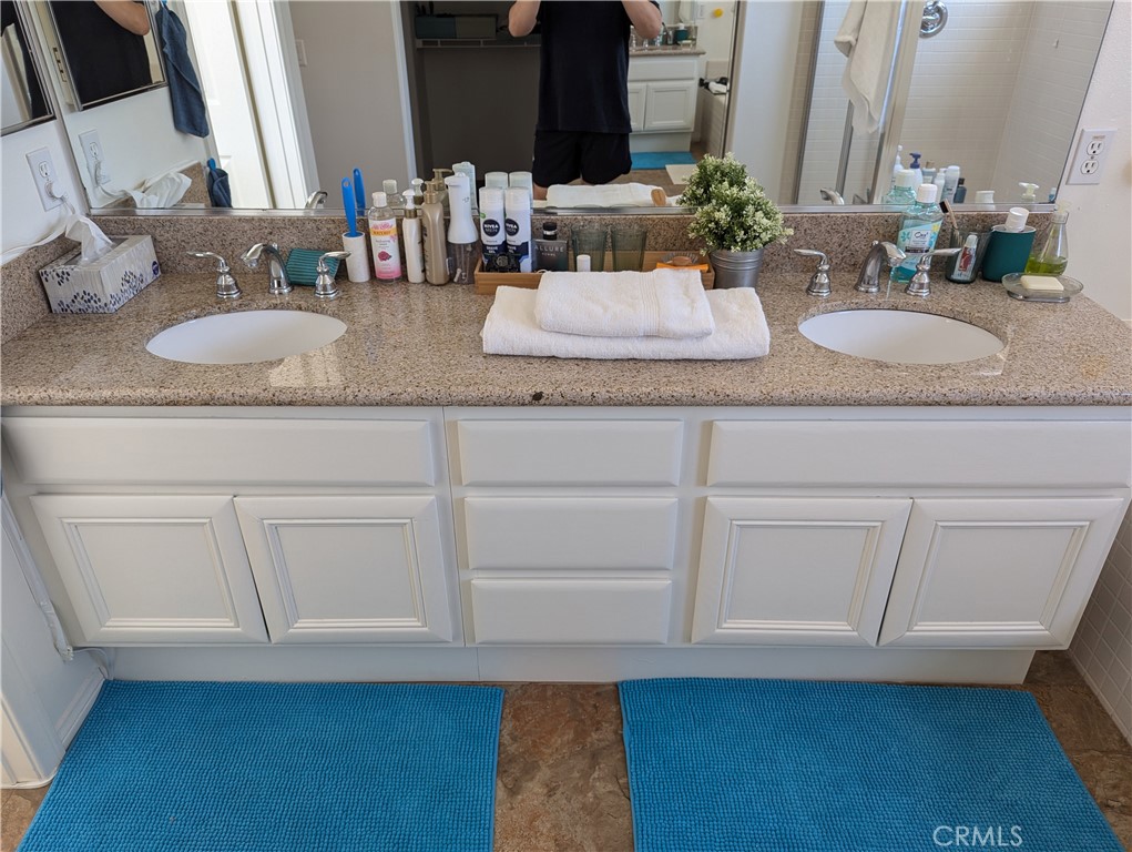 18536 Vantage Pointe Drive Rowland Heights, CA 91748 - Photo 29 of 34 a bathroom with granite countertop a sink and a mirror