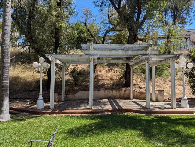 a view of a patio with a table and chairs under an umbrella
