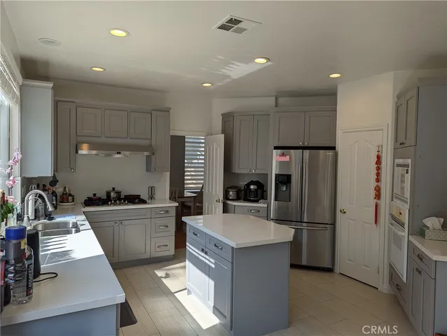 a kitchen with refrigerator a sink and cabinets