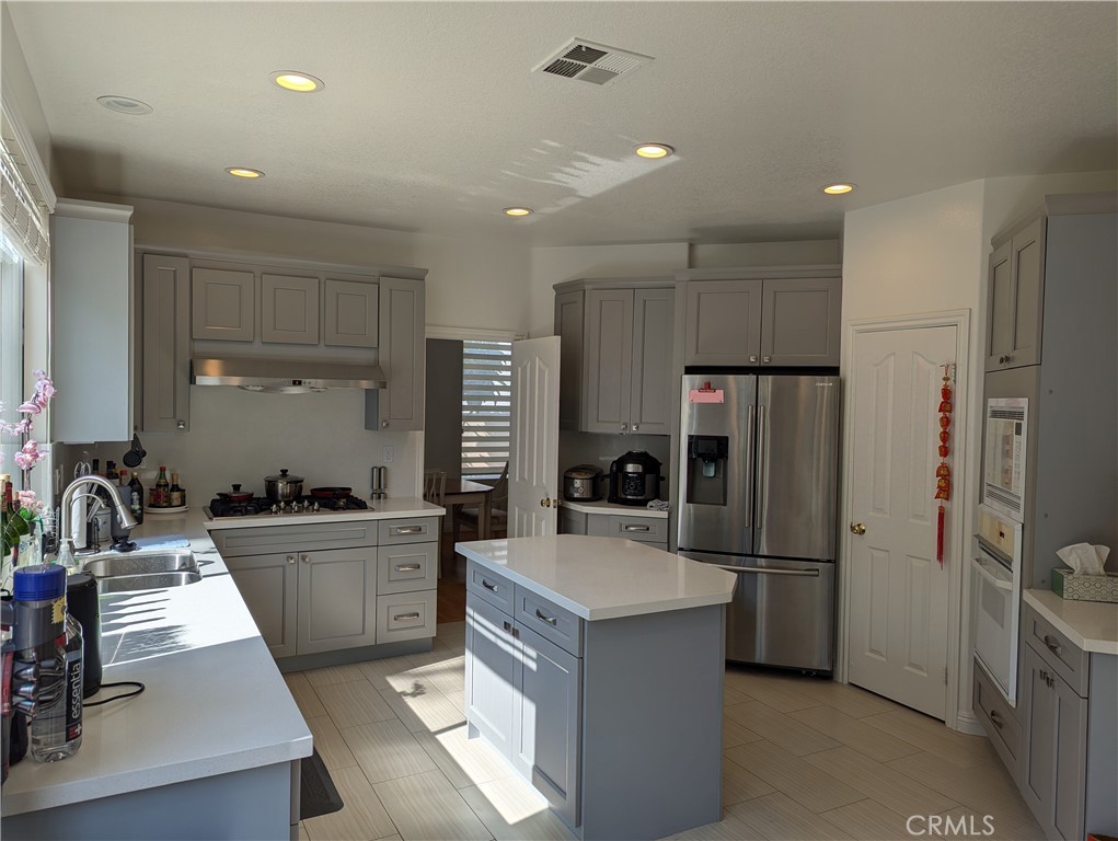 18536 Vantage Pointe Drive Rowland Heights, CA 91748 - Photo 8 of 34 a kitchen with refrigerator a sink and cabinets
