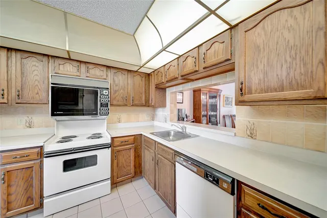 a kitchen with stainless steel appliances a stove microwave and cabinets