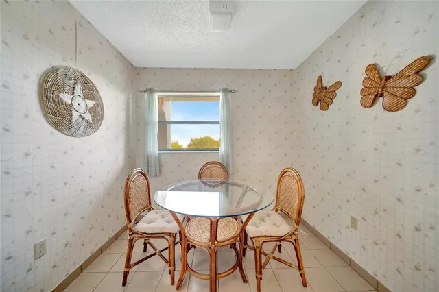 a view of a room with a table and chairs