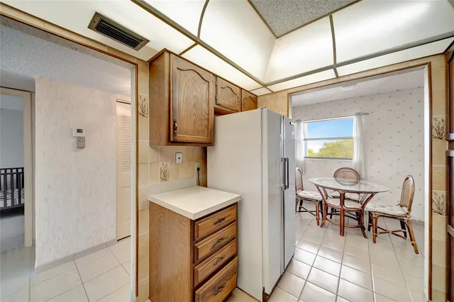 a kitchen with stainless steel appliances granite countertop a refrigerator and a stove
