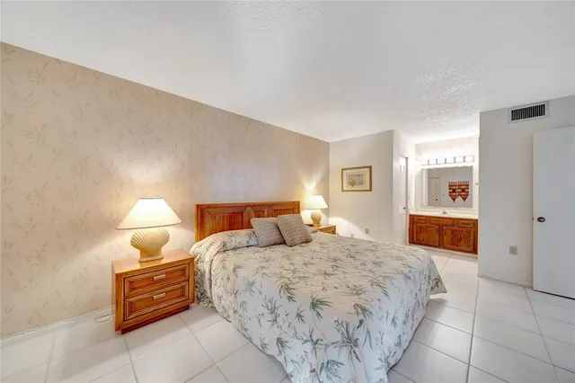 a bedroom with a bed and dresser with mirror