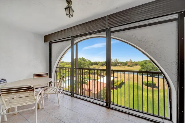 a view of a porch with furniture and floor to ceiling window