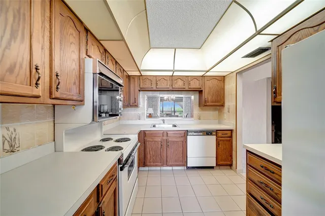 a kitchen with a sink a stove and cabinets
