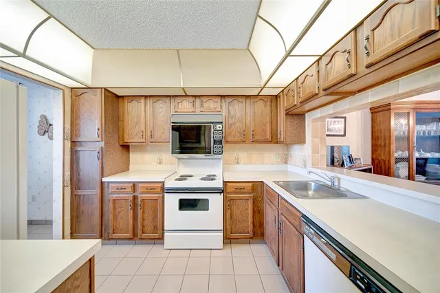 a kitchen with a sink cabinets and stainless steel appliances