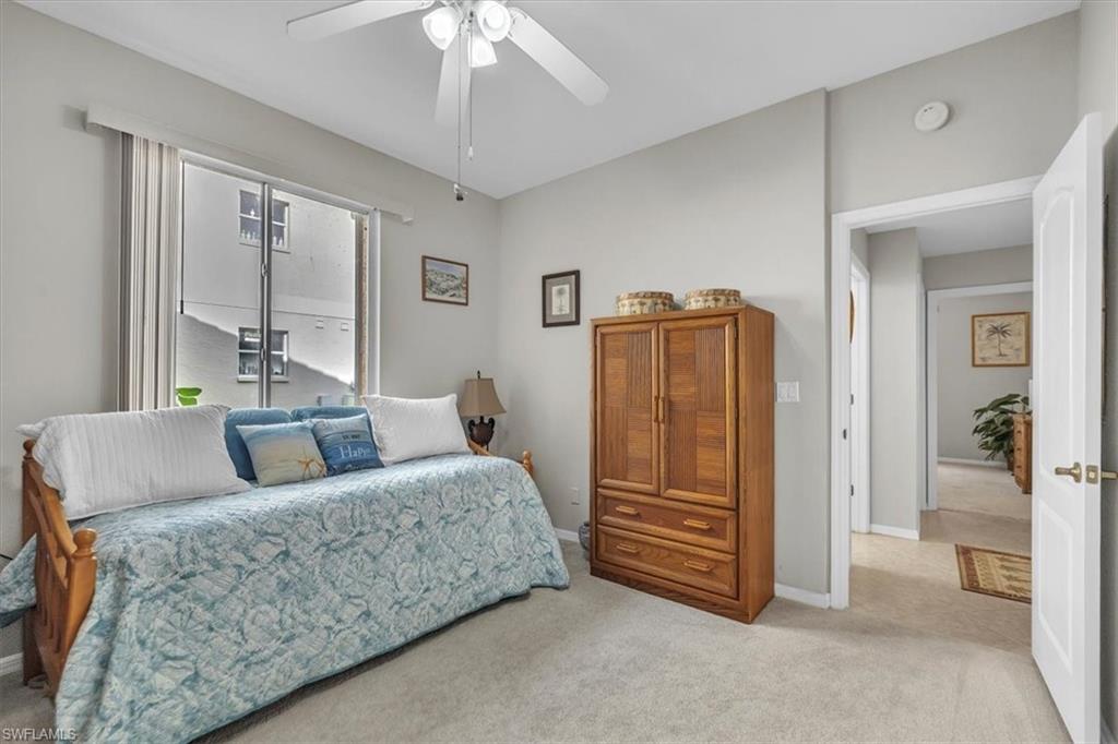 8075 Tiger Cove, Unit 1706 Naples, FL 34113 - Photo 23 of 50 Carpeted bedroom with a ceiling fan and baseboards