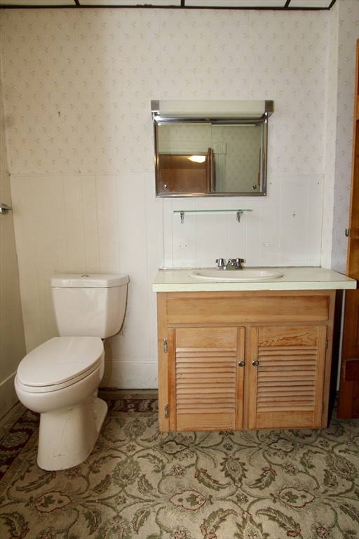 18 South Stowell Street Worcester, MA 01604 - Photo 12 of 16 a bathroom with a toilet sink and mirror