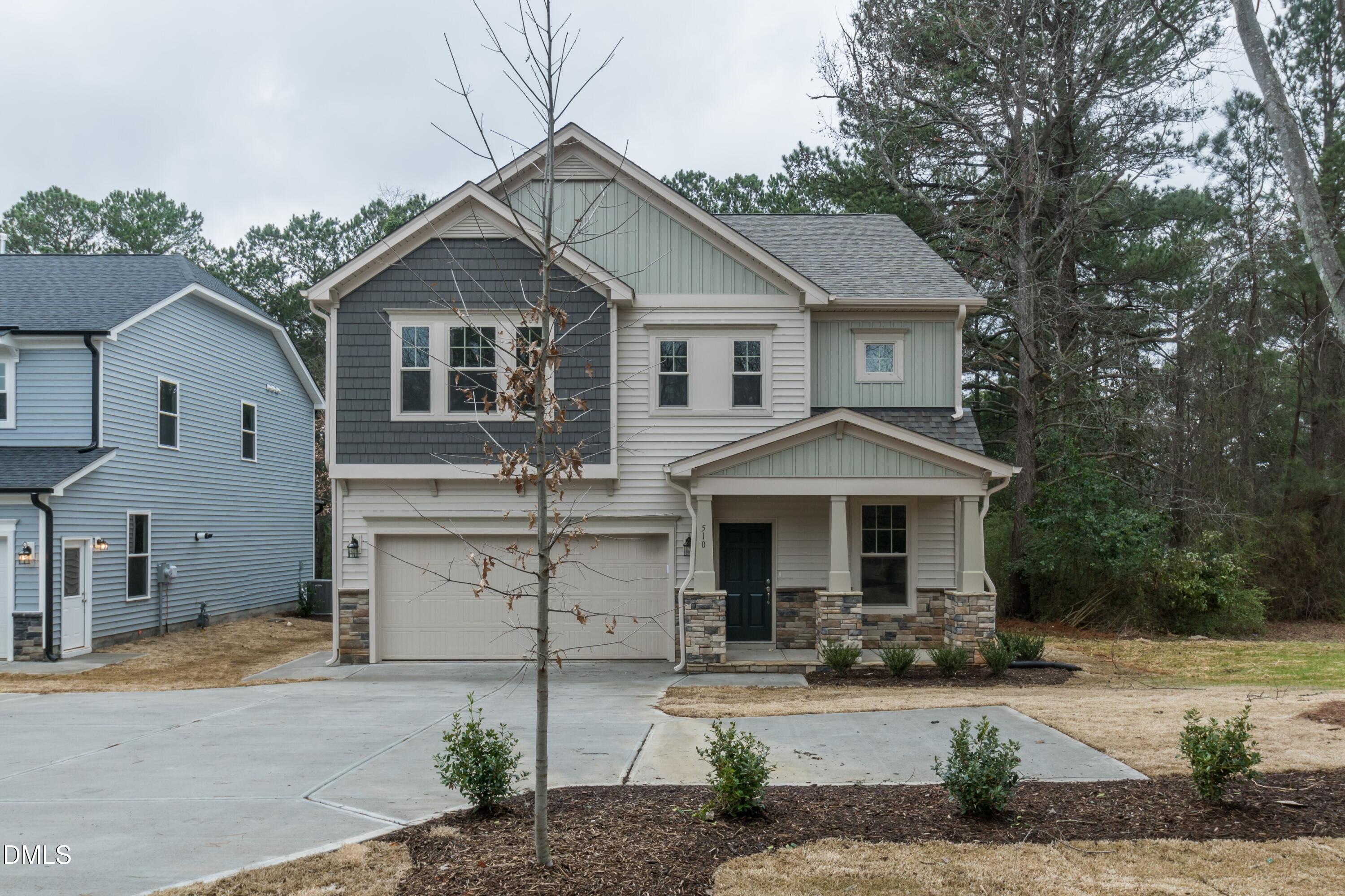 a front view of a house with garage