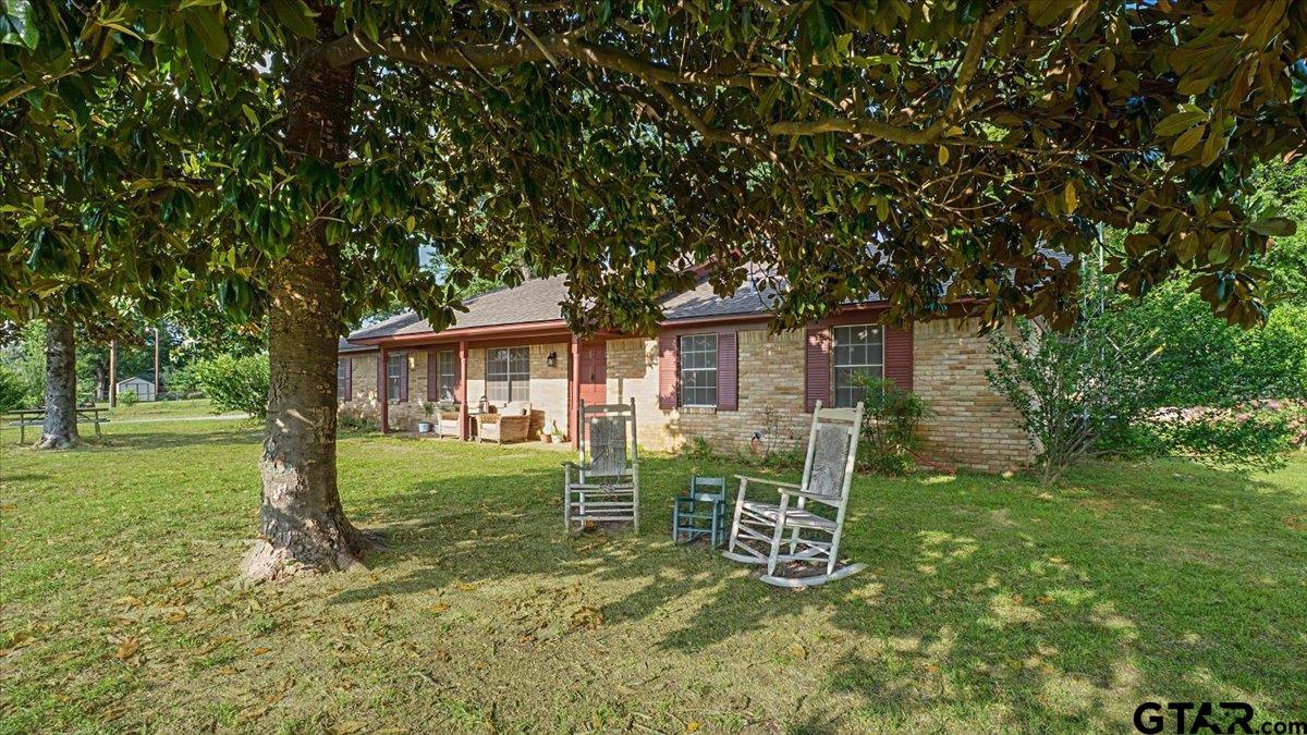 8192 County Road 428 Tyler, TX 75704 - Photo 31 of 38 a backyard of a house with table and chairs