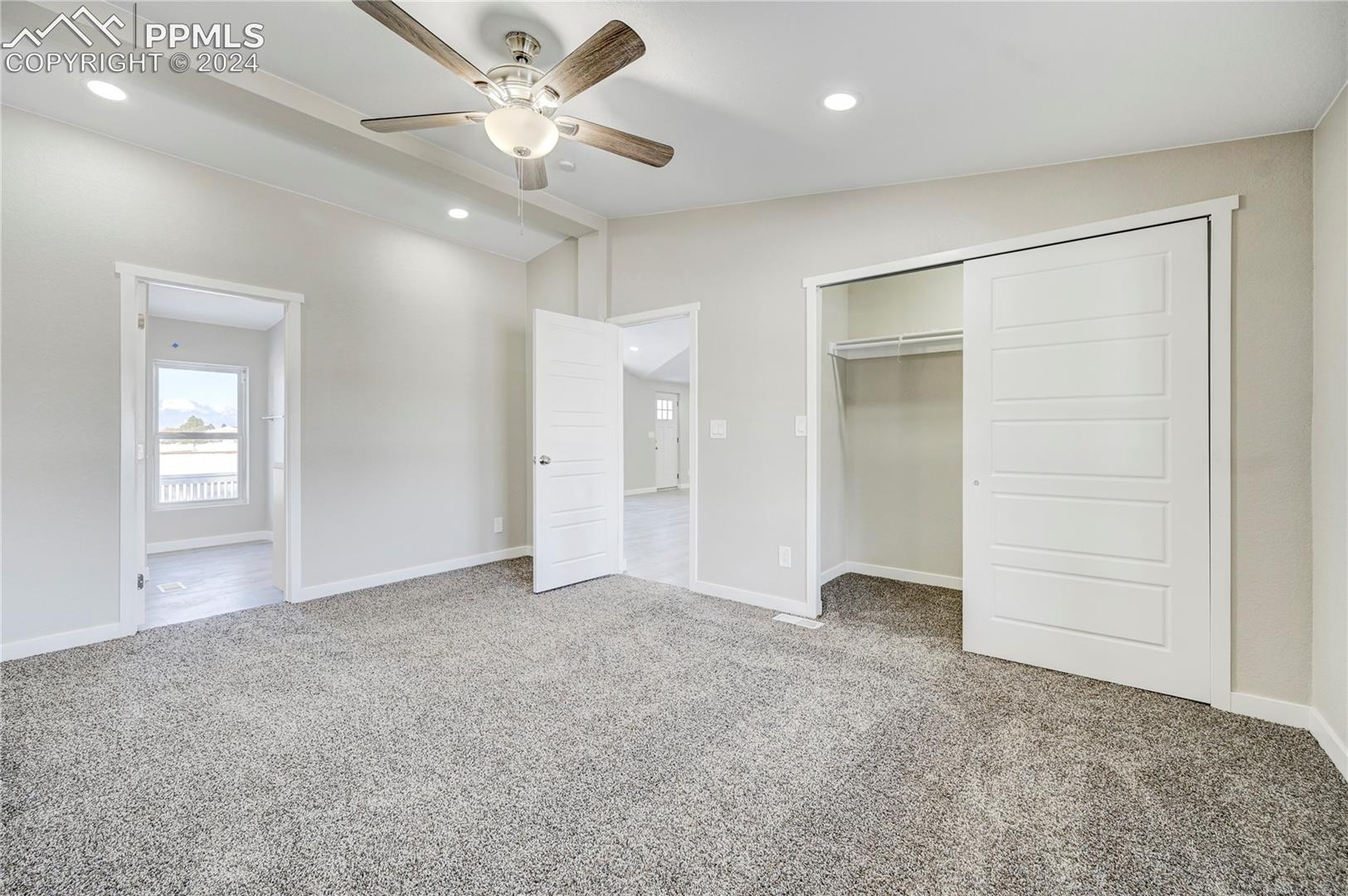 6605 Rio Road Peyton, CO 80831 - Photo 39 of 45 Unfurnished bedroom featuring ceiling fan, carpet floors, and vaulted ceiling