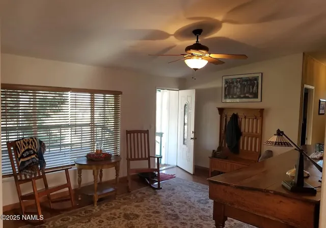 a view of a livingroom with furniture and a window