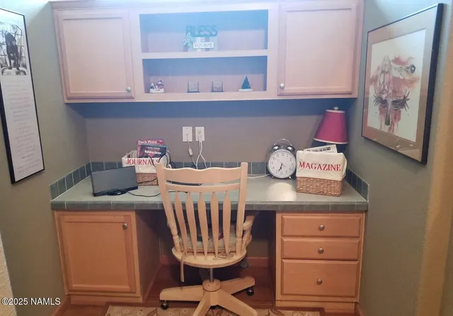 a room with a table chairs and cabinets