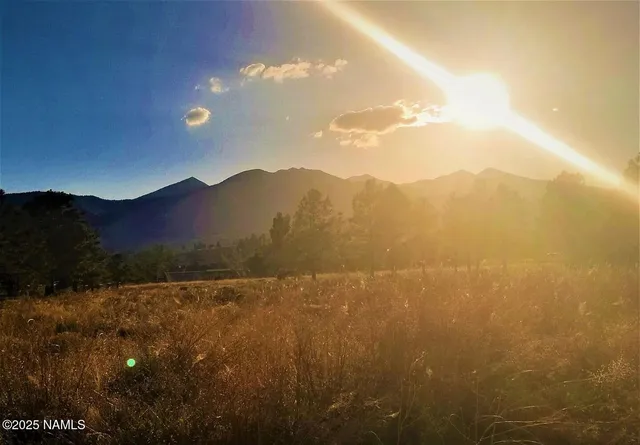 a view of mountain with sunset
