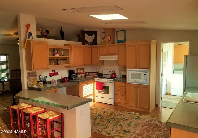 a kitchen with stainless steel appliances granite countertop a stove refrigerator and cabinets