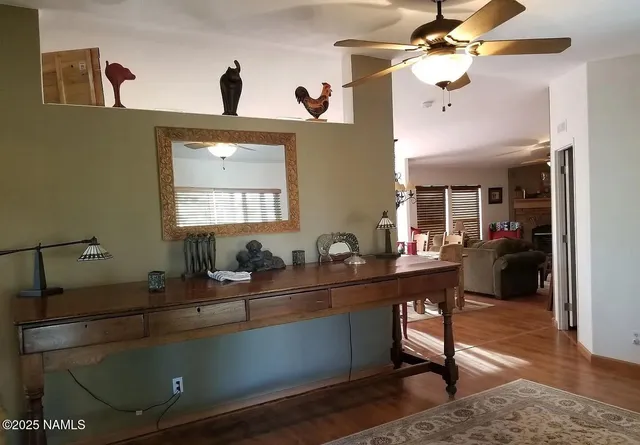 a room with a table chairs and a chandelier