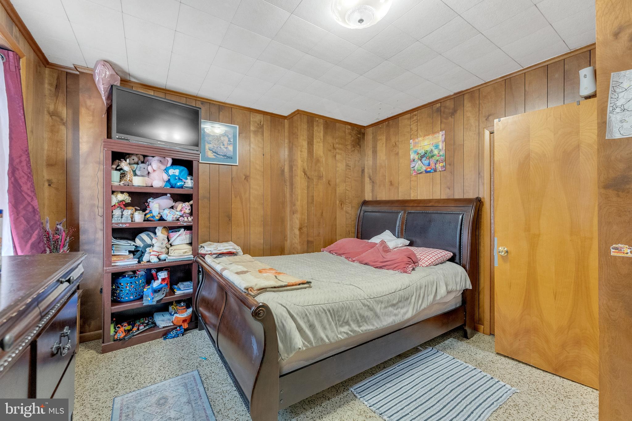 152 Division Street Trenton, NJ 08611 - Photo 15 of 24 a bedroom with a bed and a bookshelf