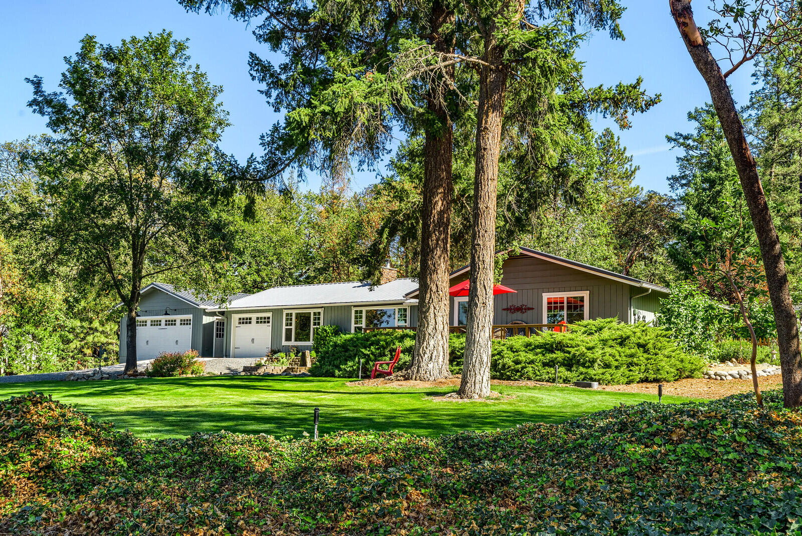 1011 Upper Applegate Road Jacksonville, OR 97530 - Photo 2 of 49 a front view of a house with a yard and trees