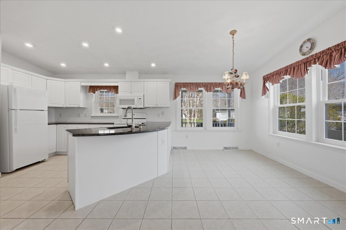 25 Heather Brook Road Montville, CT 06382 - Photo 15 of 39 a kitchen with stainless steel appliances granite countertop a sink and a refrigerator