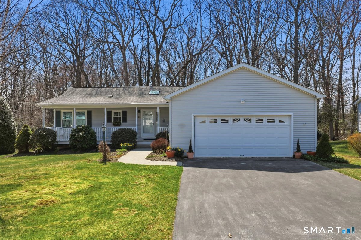 25 Heather Brook Road Montville, CT 06382 - Photo 3 of 39 a front view of a house with a yard and garage