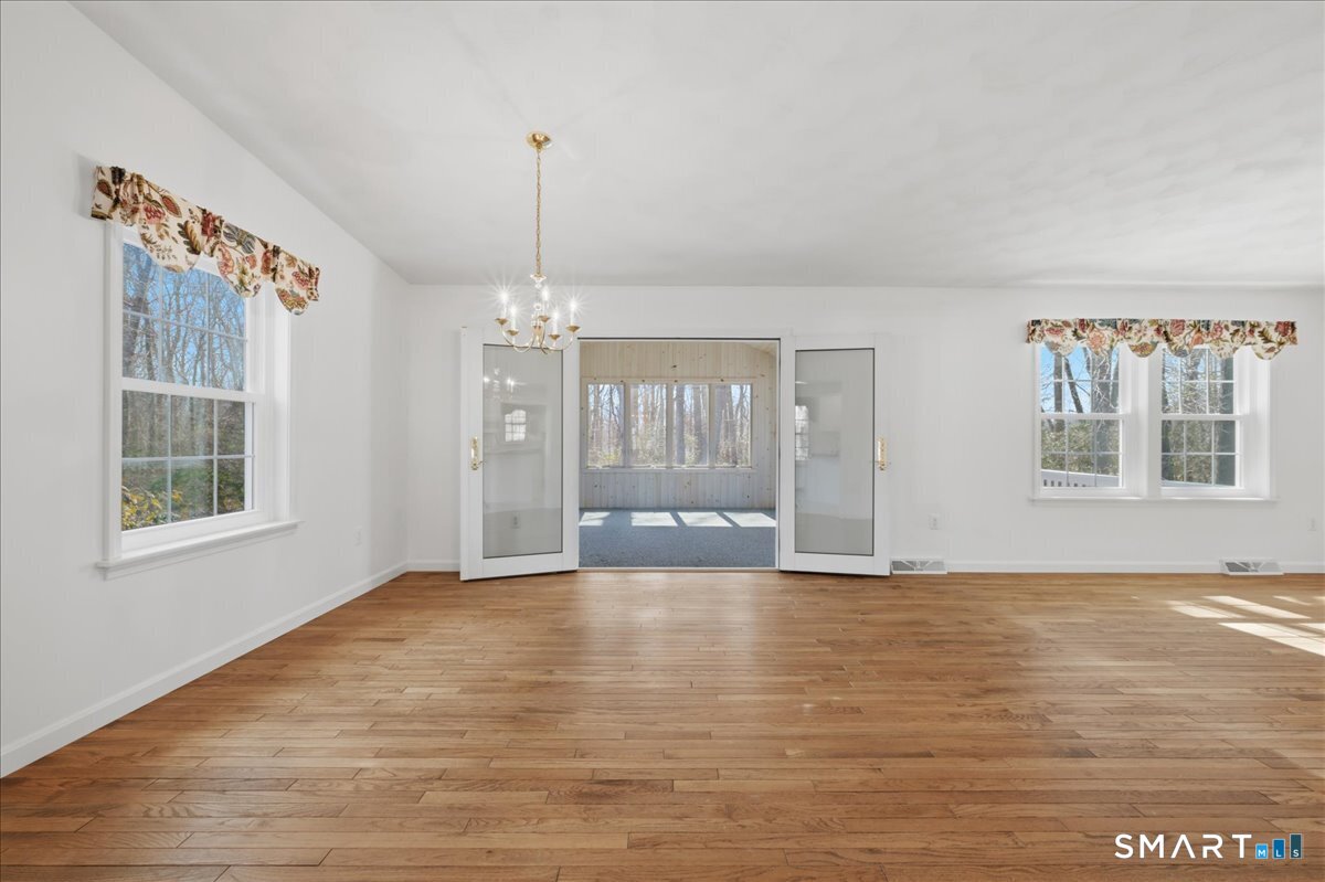25 Heather Brook Road Montville, CT 06382 - Photo 8 of 39 a view of an empty room with a window and wooden floor