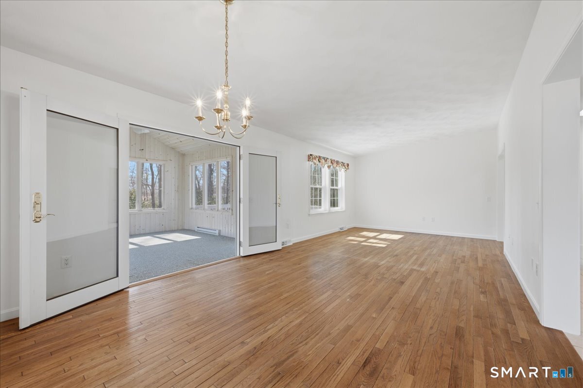 25 Heather Brook Road Montville, CT 06382 - Photo 10 of 39 a view of a livingroom with wooden floor and chandelier