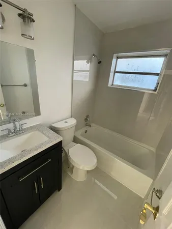 a bathroom with a double vanity sink toilet and shower
