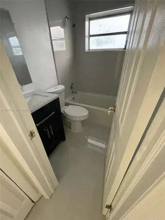 a bathroom with a sink a toilet and a shower