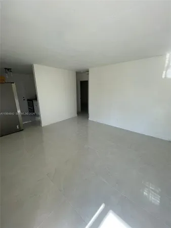 a view of an empty room and a sink