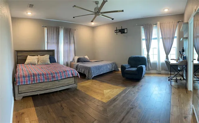 a spacious bedroom with two beds and a couch