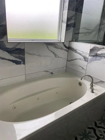 a bathroom with a bathtub and shower