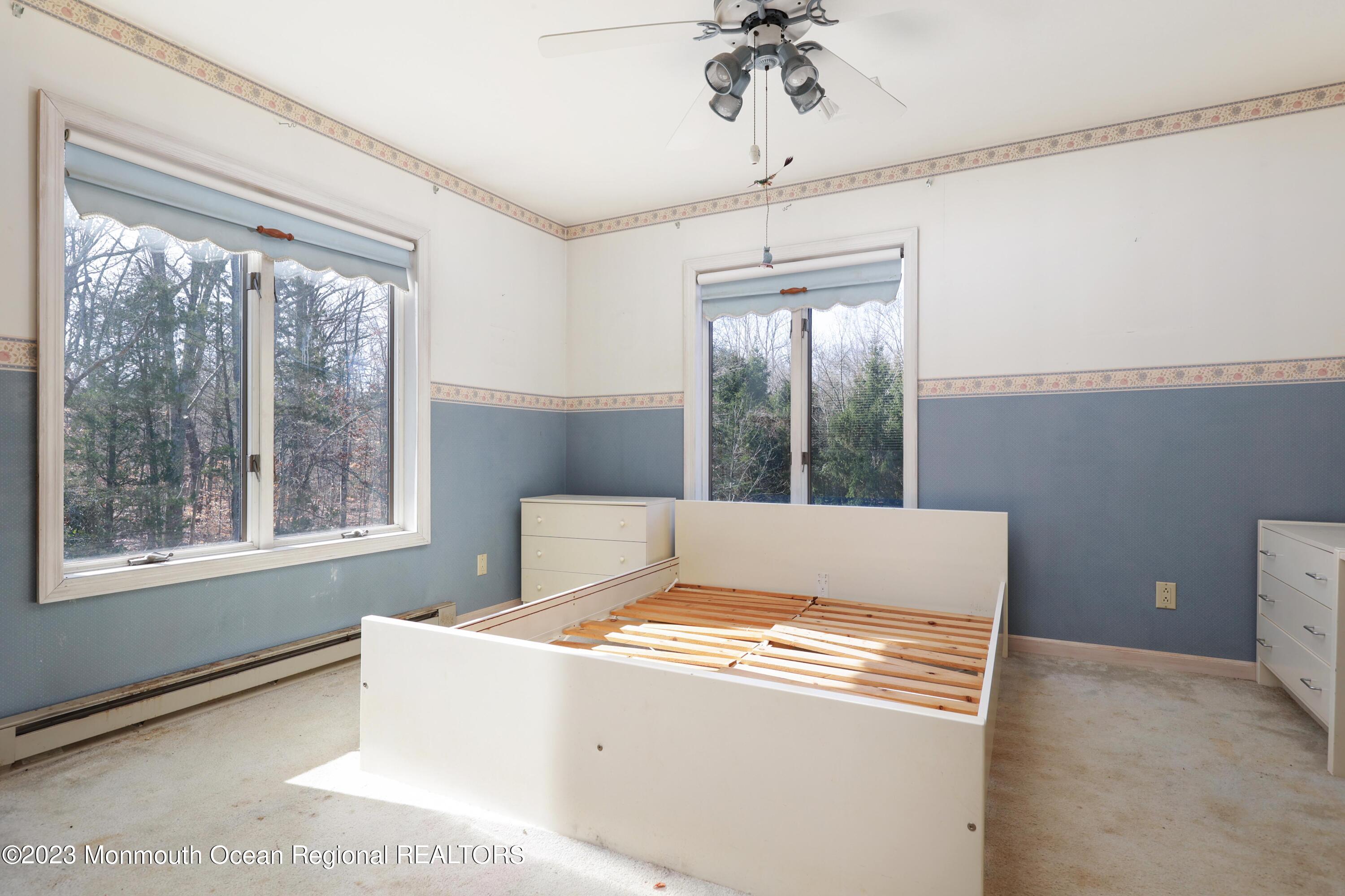 25 Meirs Road Cream Ridge, NJ 08514 - Photo 14 of 17 a bed sitting in a bedroom next to a window
