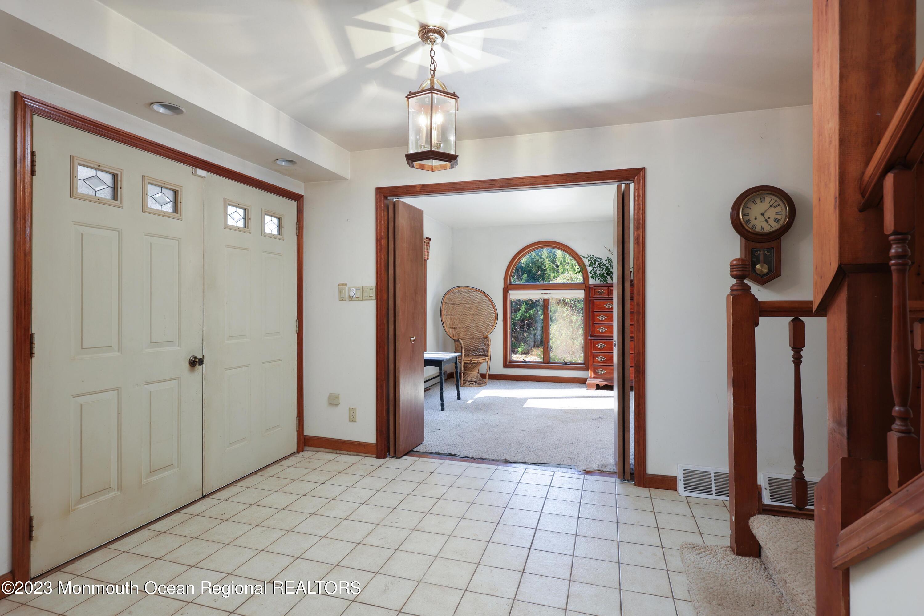 25 Meirs Road Cream Ridge, NJ 08514 - Photo 6 of 17 a view of a hallway with entryway windows and a chandelier