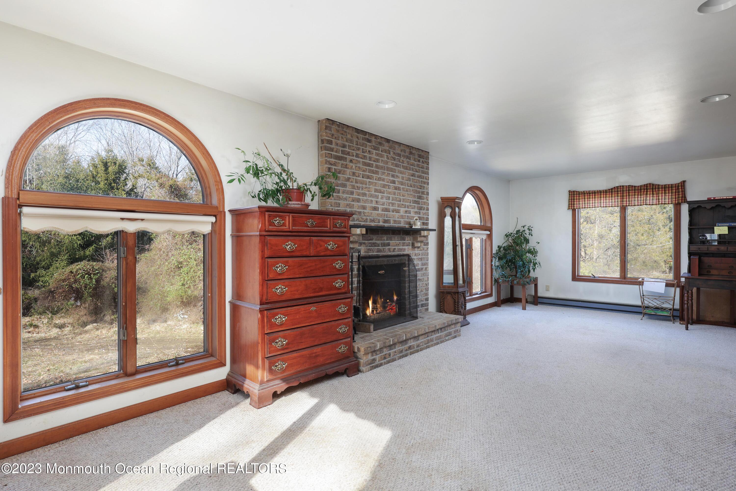 25 Meirs Road Cream Ridge, NJ 08514 - Photo 7 of 17 wooden floor in an empty room with a fireplace