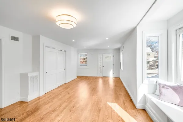 a view of a room with wooden floor and window