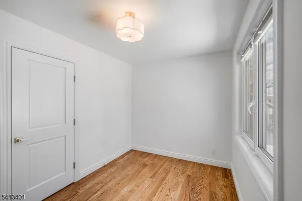 a view of room with window and hardwood floor