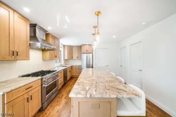 a kitchen with stainless steel appliances granite countertop a sink and stove top oven