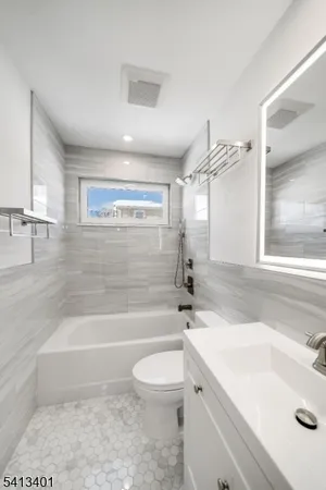 a bathroom with a sink a toilet and bathtub