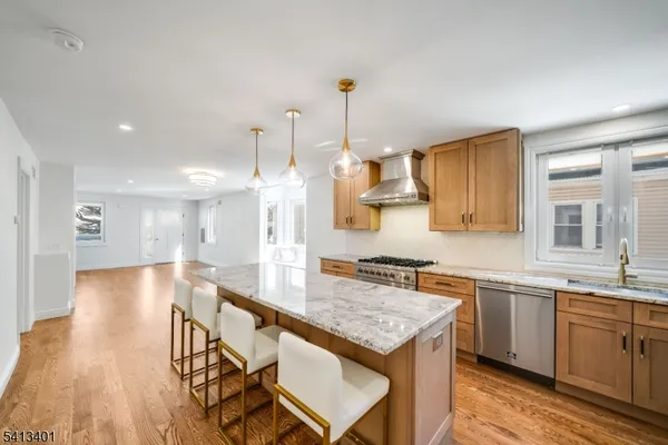 a kitchen with kitchen island a sink stove and wooden floor