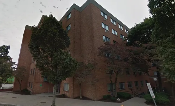 a front view of a building with a yard