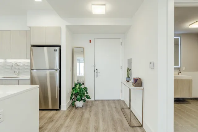 a view of a kitchen from a hallway