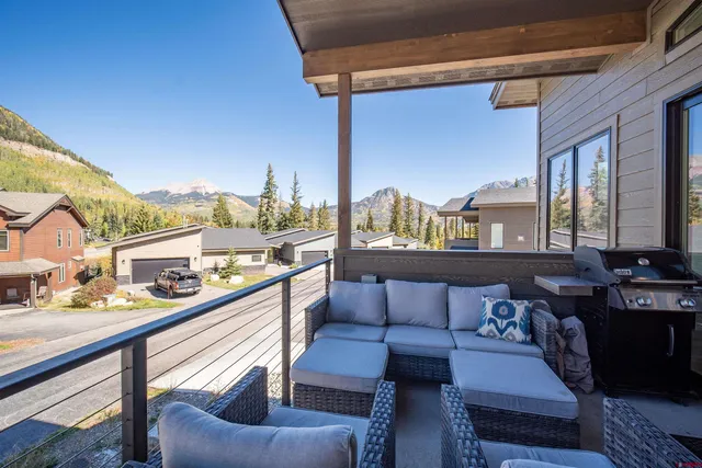 a balcony with furniture and view of city