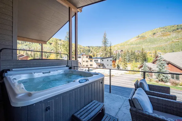 a view of a living room and kitchen with a sink