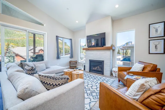a living room with furniture and a fireplace