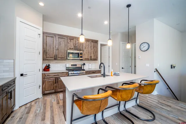 a kitchen with sink cabinets and wooden floor