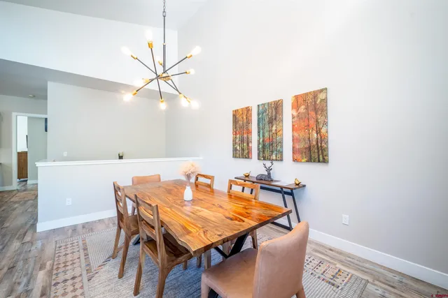 a view of a dining room with furniture and a chandelier