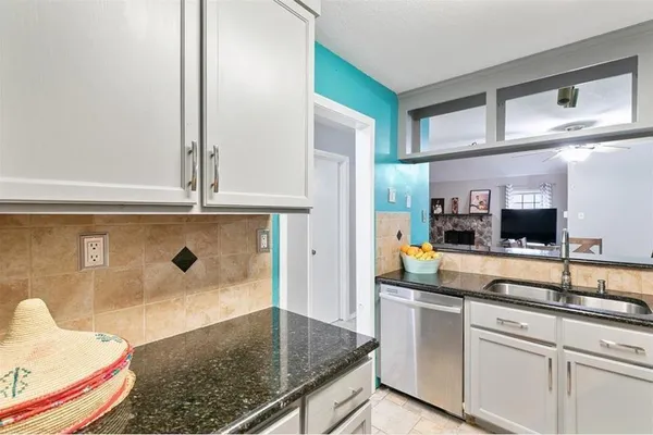 a kitchen with stainless steel appliances granite countertop a sink and cabinets
